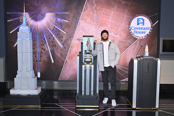 NY Knicks player Jalen Brunson at Empire State Building on behalf of Covenant House 