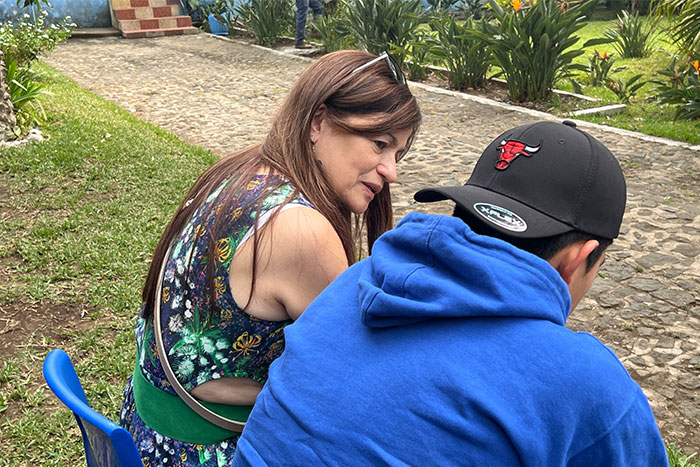 Latin American homeless teen talking to adult