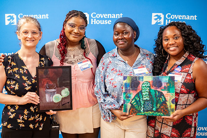 Covenant House New York youth art show artists and patrons holding works of art