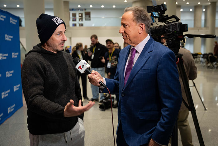 Covenant House Sleep Out participant talking to news correspondent