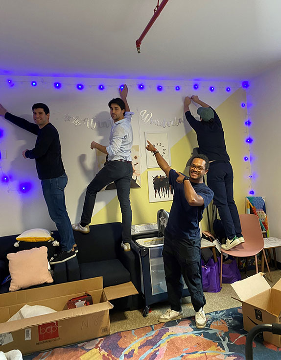 Ardian group photo that shows the staff decorating a room for the holidays | Covenant House Corporate Partner