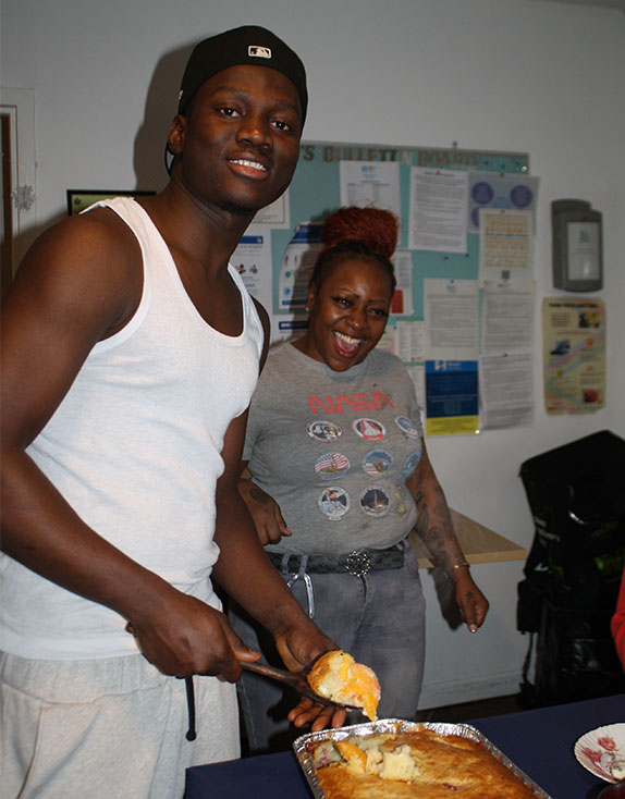 Covenant House youth serving holiday meal