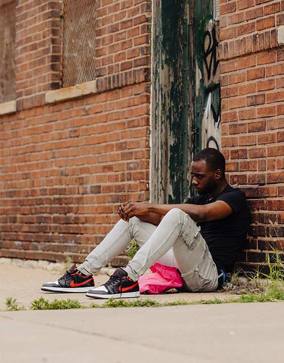 homeless teenage boy sitting outside | Covenant House