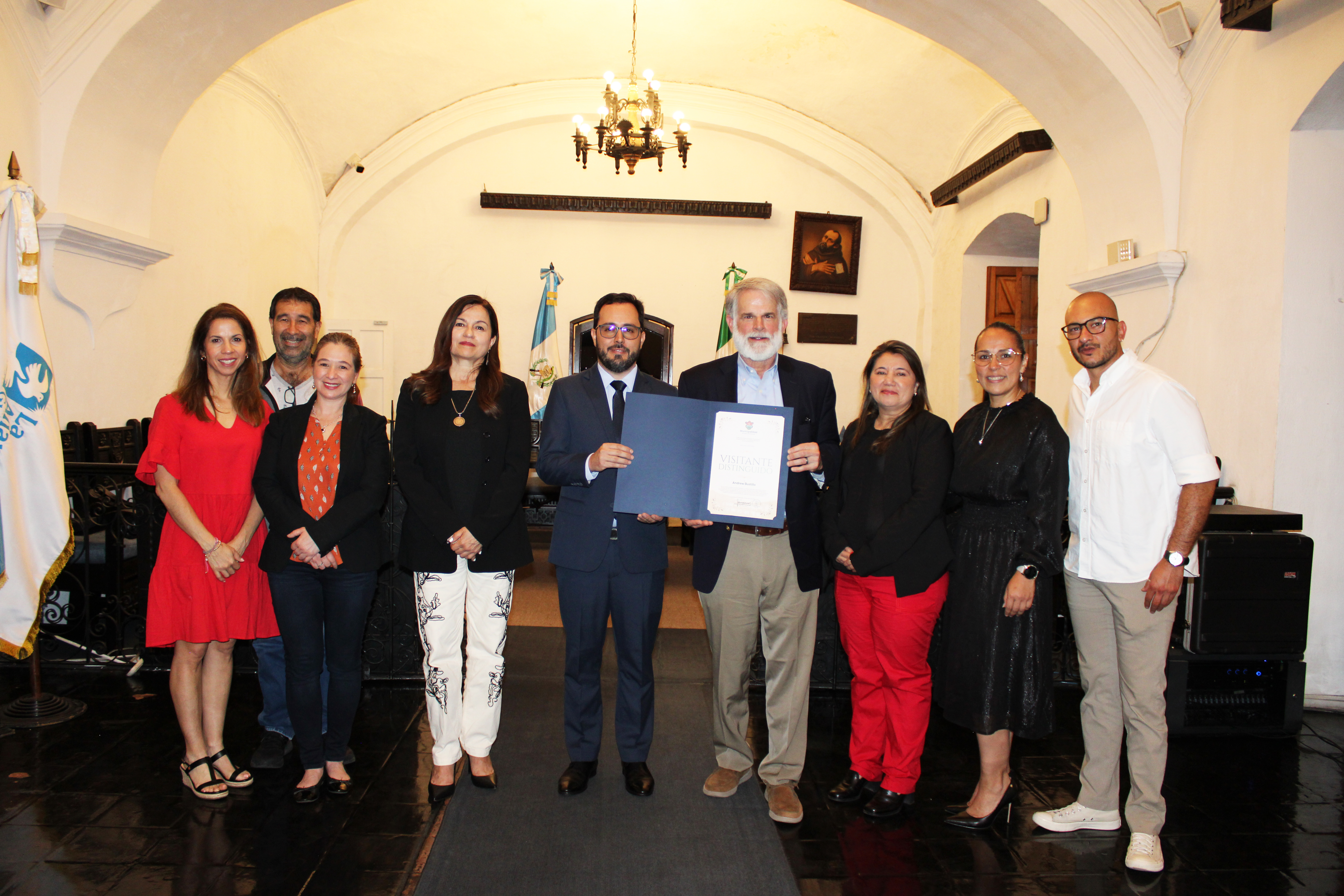 Andrew Bustillo (with beard) and Antigua Mayor Juan Manuel Asturias Sueiras hold certificate of recognition, along with Covenant House Guatemala staff, including CEO Carolina Escobar Sarti (left of Asturias Sueiras) and CHI AVP Latin America Evelyn Homs Medero (far left).