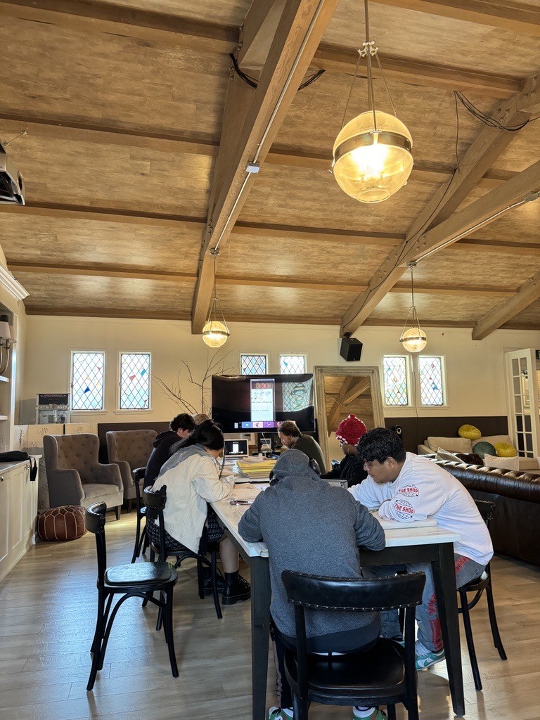 Residents at Covenant House California studying around a table.