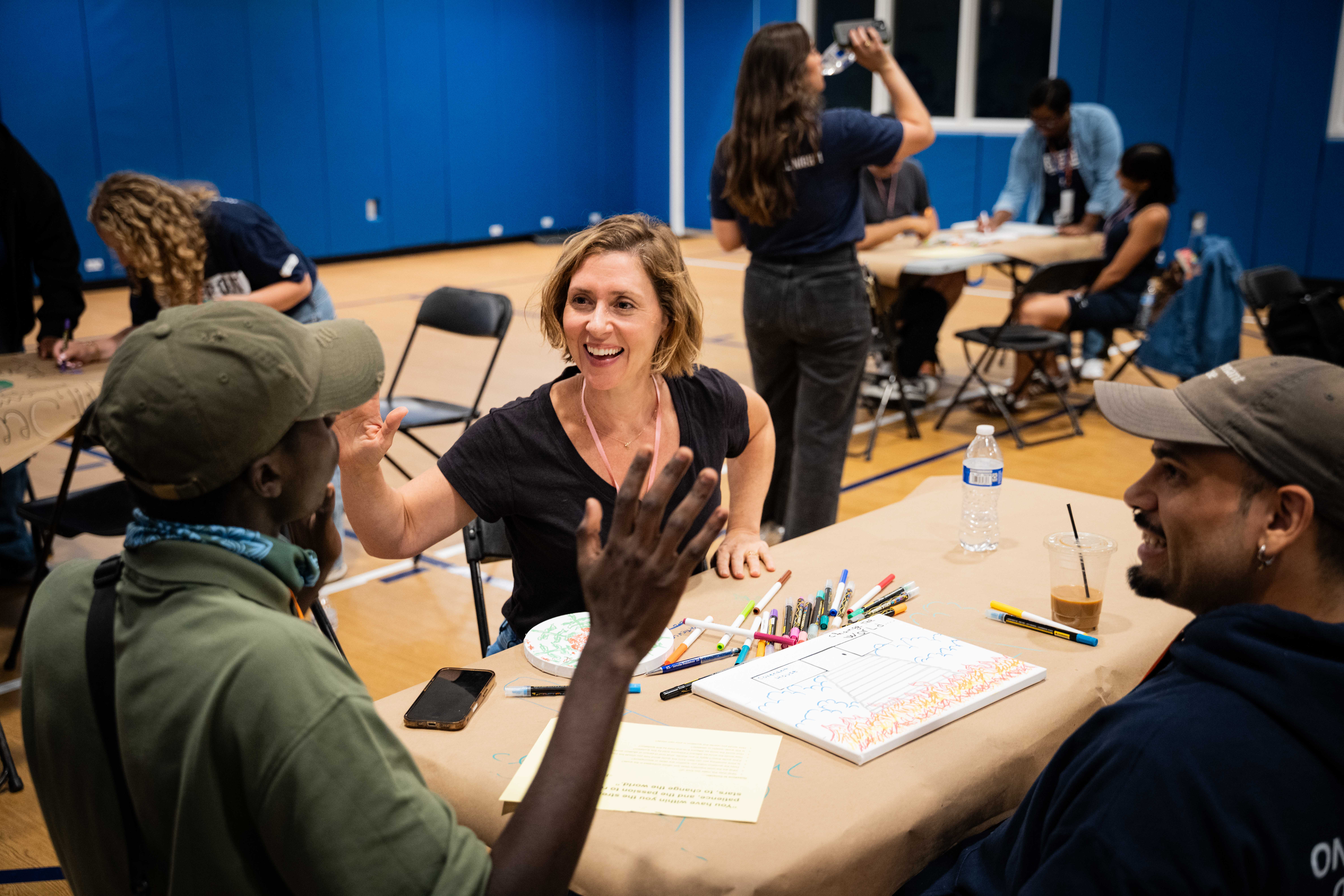 Actor Miriam Silverman high-fives another Sleep Out participant during a breakout session.
