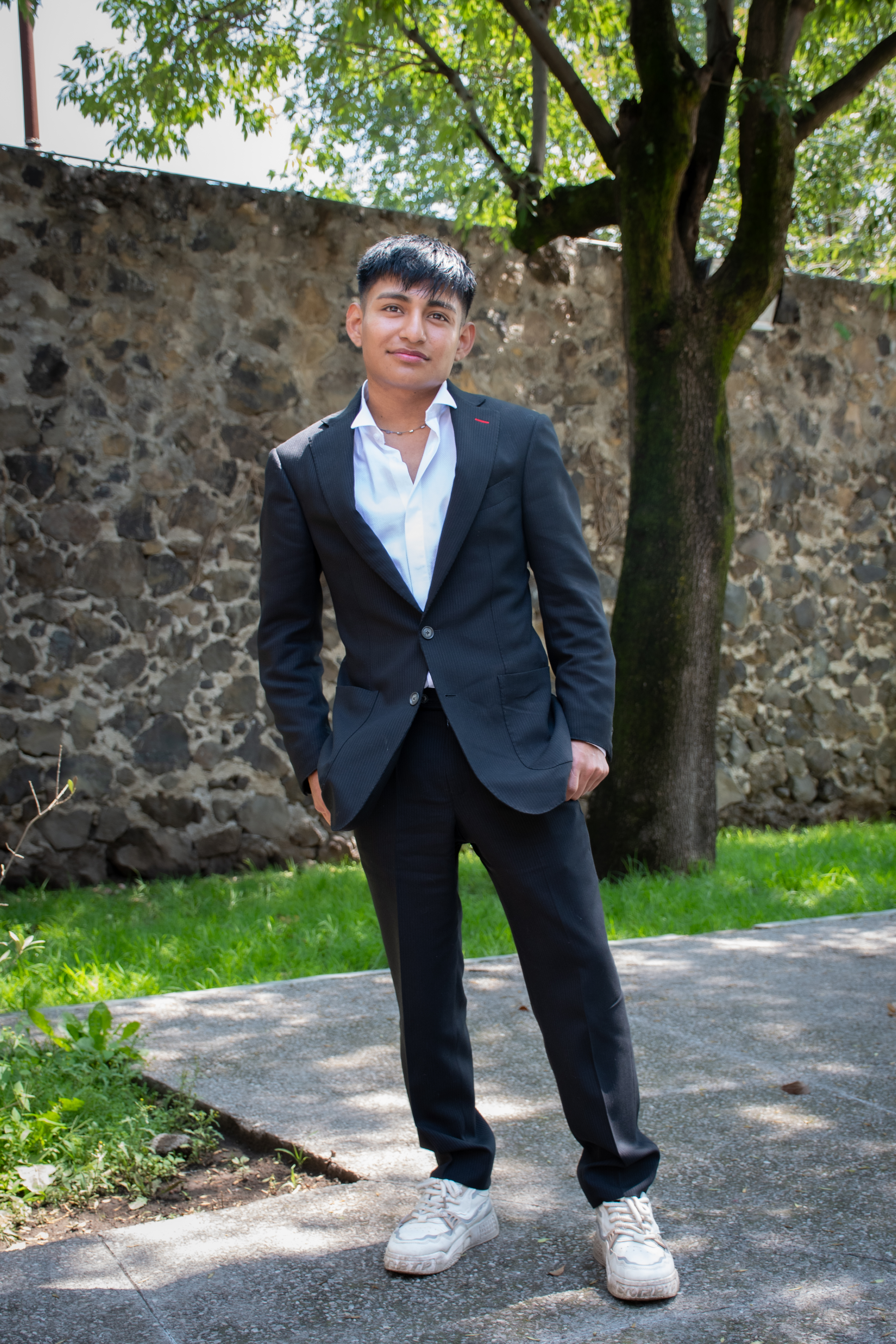 Full-length photo of Edwin standing outside of the chapel at Covenant House Mexico.