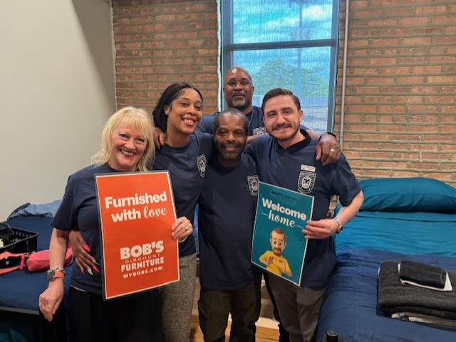 Covenant House staff with the beds donated by Bob's Furniture.