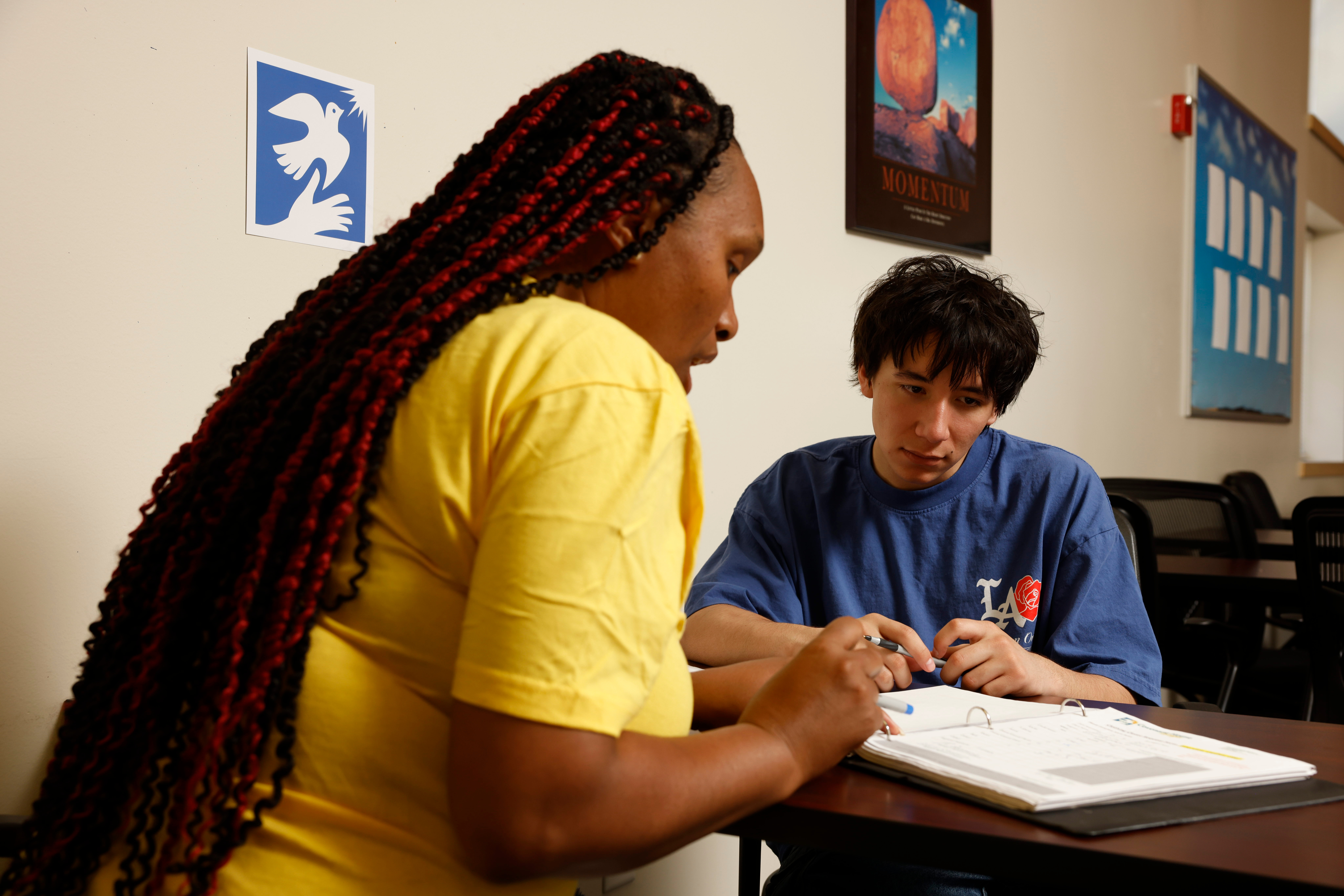At Covenant House Alaska, a staff member helps a youth with paperwork.