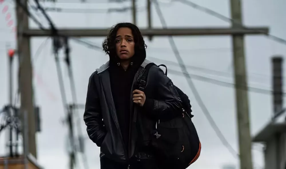 Young man walking outdoors with a backpack