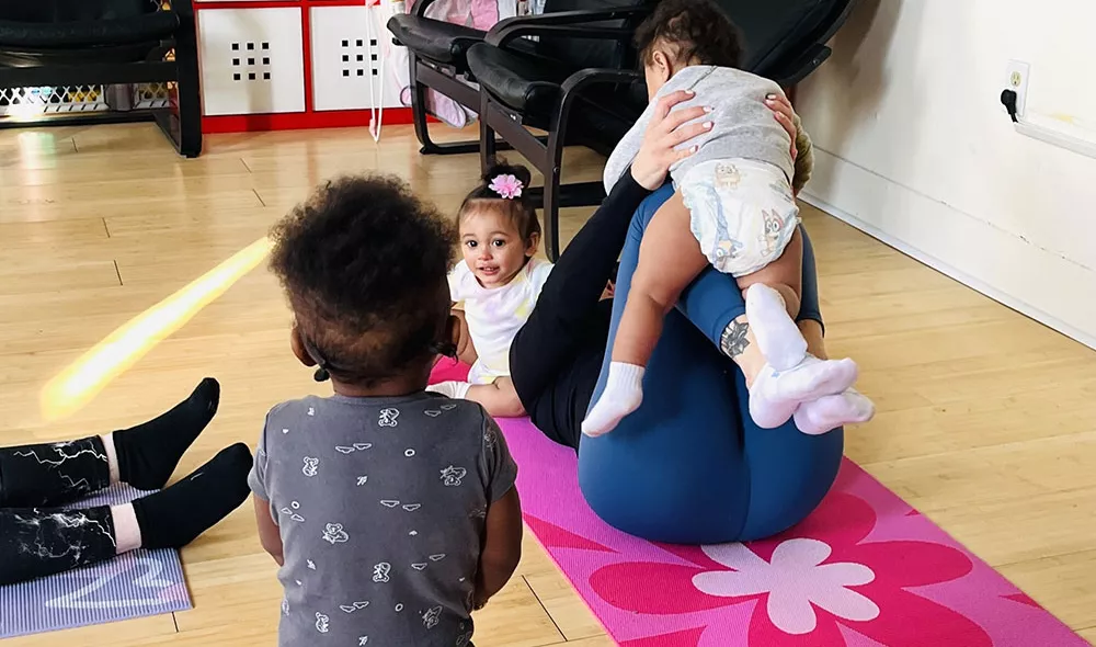 homeless young moms and babies on yoga mats | Covenant House