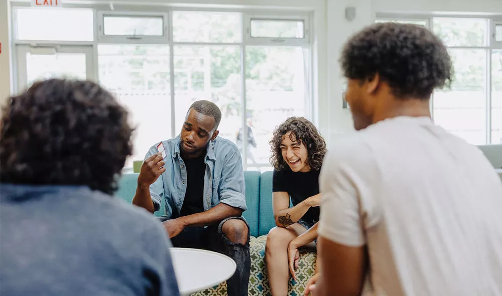 Former homeless teens socializing in Covenant House community room