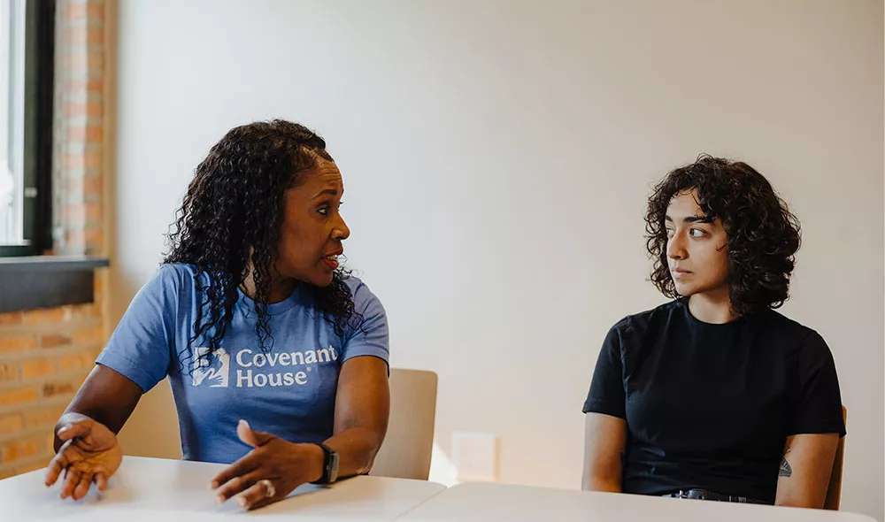 Covenant House homeless youth with staff in the middle of a conversation