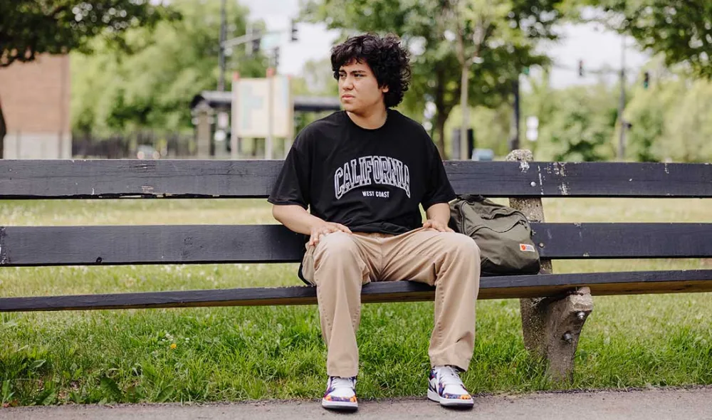 homeless youth sitting on park bench outside | Covenant House