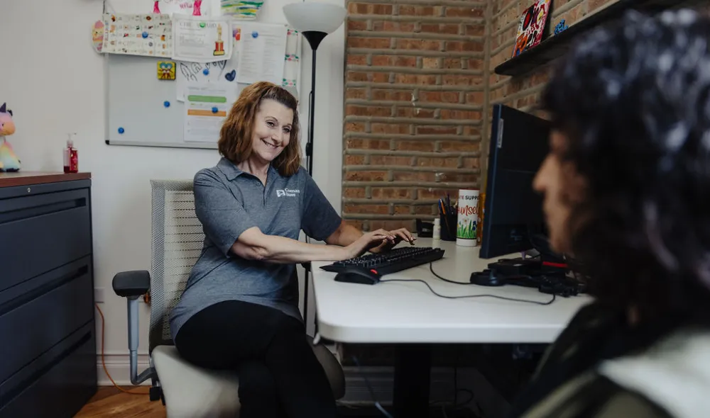 Covenant House counselor meeting with a young woman.