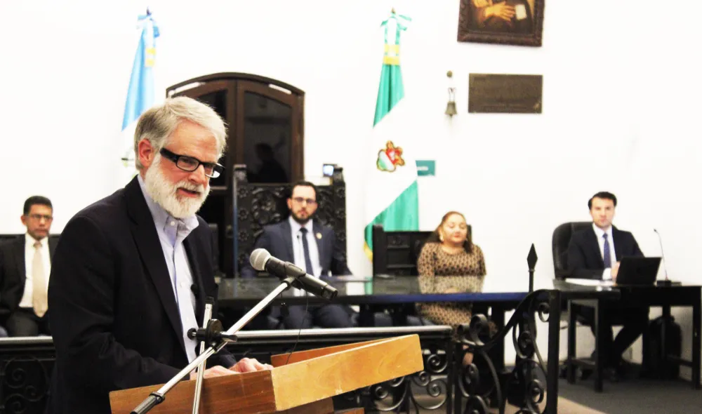 Longtime Covenant House supporter Andrew Bustillo addresses Antigua Mayor Juan Manuel Asturias Sueiras, municipal officials, and guests at a ceremony in Antigua, Guatemala, where he was recognized as a Distinguished Visitor.