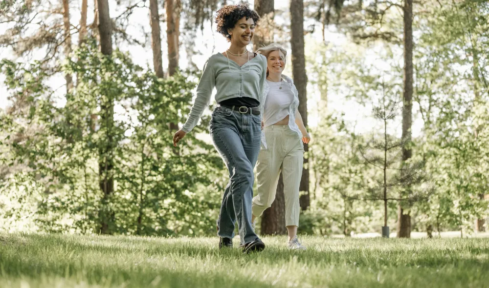 Young, happy couple walking together in the park on a sunny day.