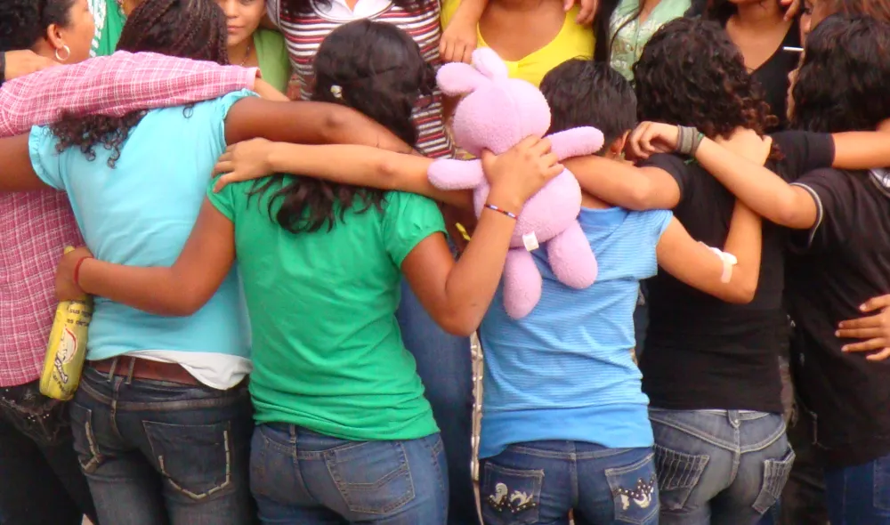 Residents of Covenant House Honduras in the embrace of a group hug.