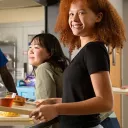 Young girl carrying tray of food. We help homeless kids by providing meals. Please donate today. | Covenant House Donations - Ways to Give