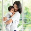 Former homeless youth Sophia and child in her arms | Covenant House
