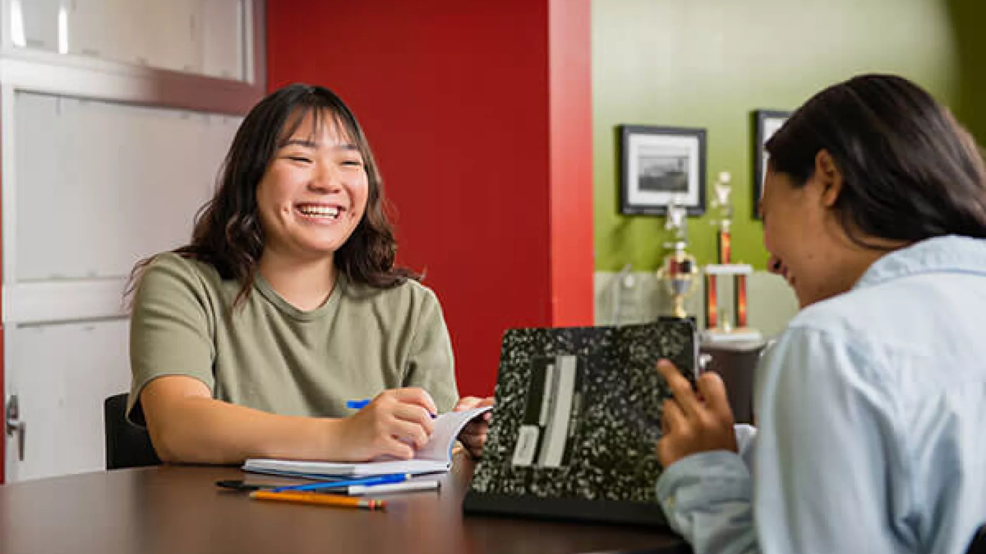 Two young Covenant House residents working together at a table