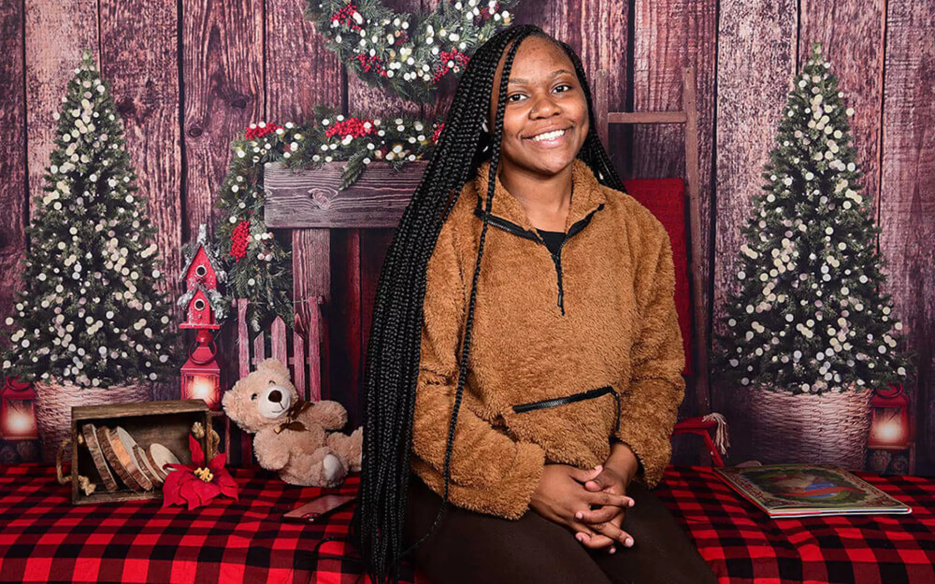 Young woman smiling in front of a Christmas Tree at Covenant House