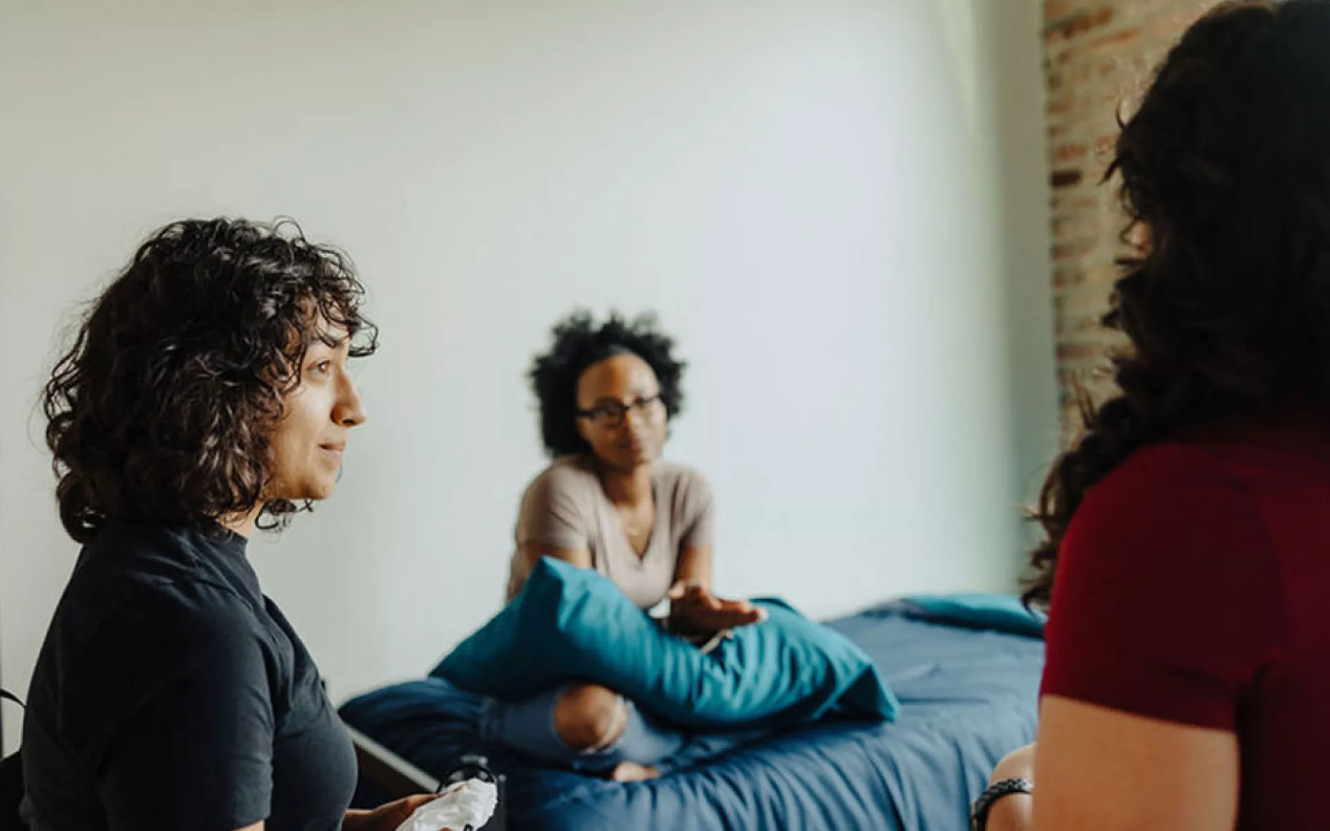 homeless youth gathered in dorm room at Covenant House