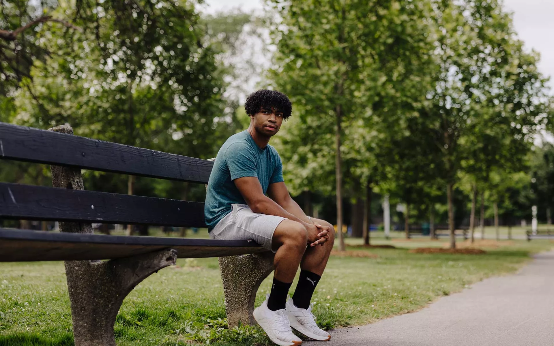 homeless teen sitting on outdoor bench | Covenant House - Donate today to support struggling homeless youth