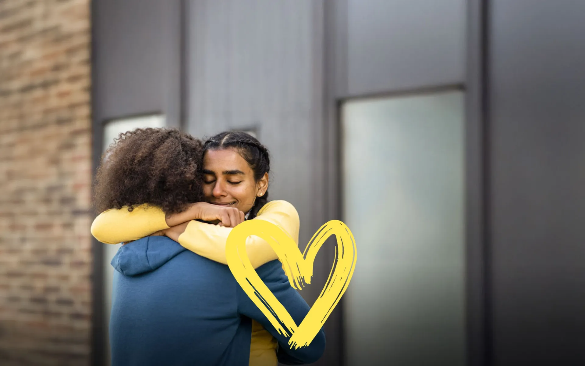 Two former homeless girls hugging each other - Random Acts of Kindness Day | Covenant House