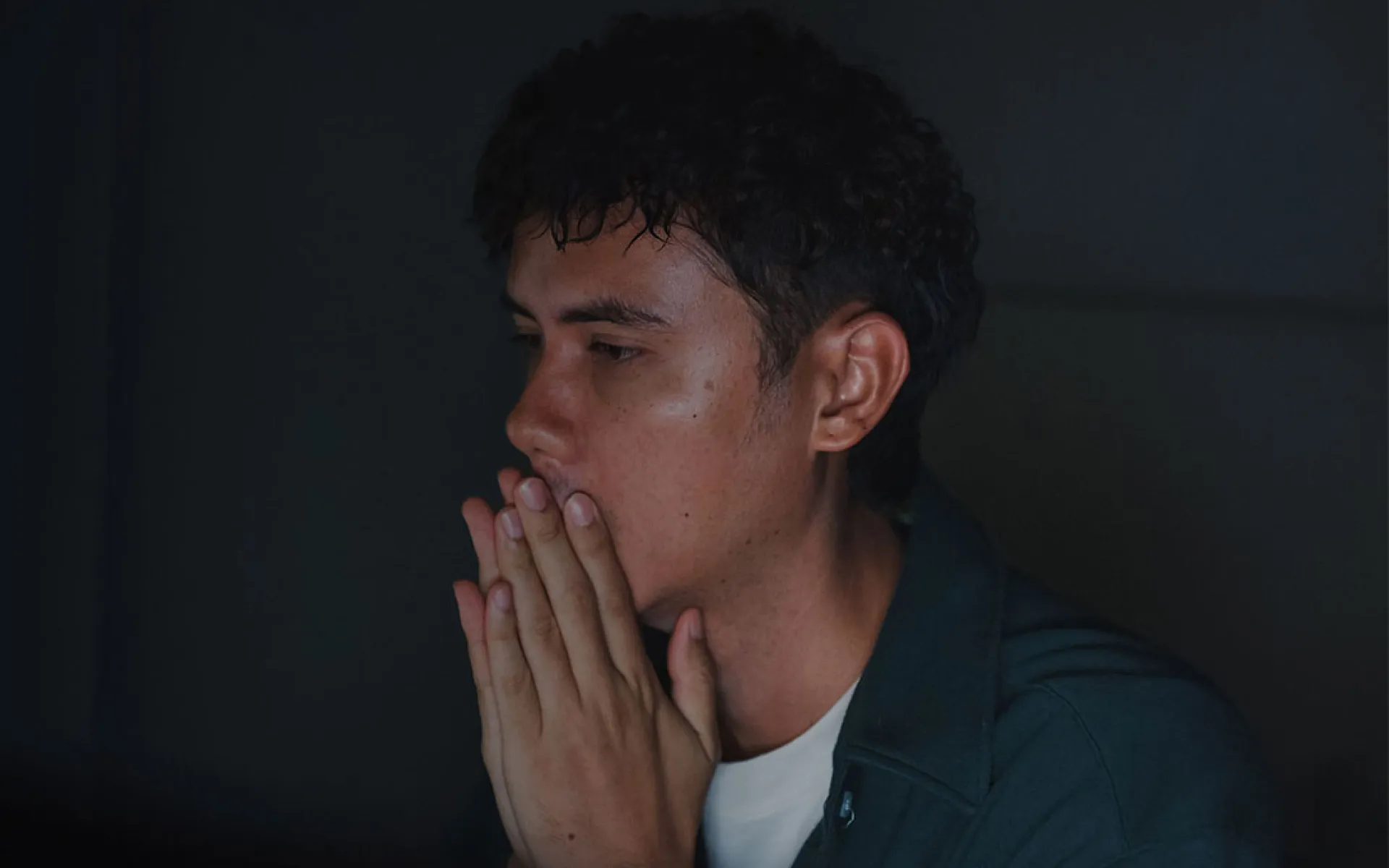 young homeless and trafficked young person praying | Covenant House