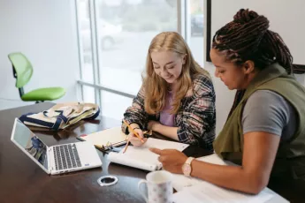 Young previously homeless women learning on a laptop