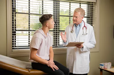 Young male receiving medical care through Covenant House