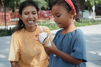 Former homeless Latin American mom with daughter holding ice cream | Covenant House - Latin America
