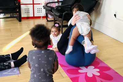 homeless young moms and babies on yoga mats | Covenant House