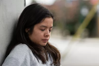Human trafficking survivor leaning against wall | Covenant House