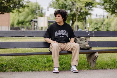 homeless youth sitting on park bench outside | Covenant House