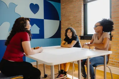 A counselor meeting with two young residents at Covenant House Chicago.