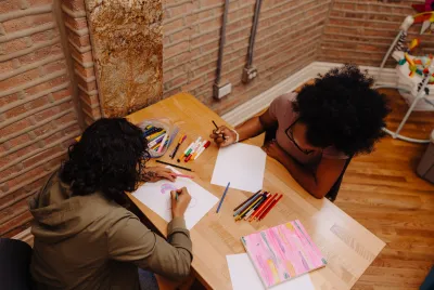 Two residents at Covenant House in Chicago work on art projects together.