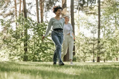 Young, happy couple walking together in the park on a sunny day.