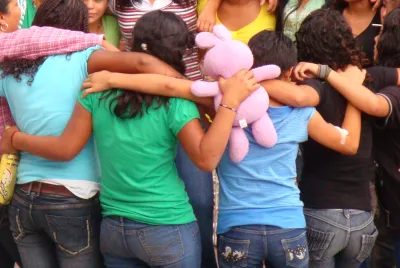 Residents of Covenant House Honduras in the embrace of a group hug.
