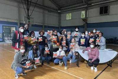 Covenant House Georgia and CHI staff pose with comfort koalas in a gymnasium at the close of a YMHFA course in 2022. The koala is a nod to Australia, where YMHFA originated.