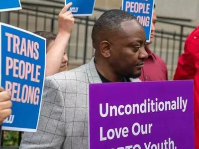 Covenant House alumni Iden protesting with sign