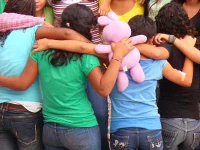 Previously homeless children in Latin America huddled together | Covenant House