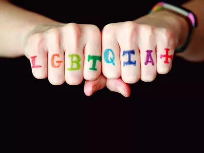 LGBTQ+ written across someone's hands | Covenant House LGBTQ+ homeless youth