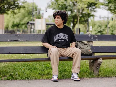 homeless youth sitting on park bench outside | Covenant House