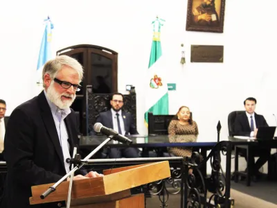 Longtime Covenant House supporter Andrew Bustillo addresses Antigua Mayor Juan Manuel Asturias Sueiras, municipal officials, and guests at a ceremony in Antigua, Guatemala, where he was recognized as a Distinguished Visitor.