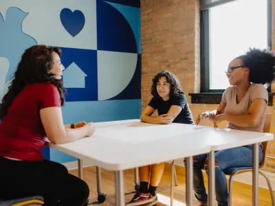A counselor meeting with two young residents at Covenant House Chicago.