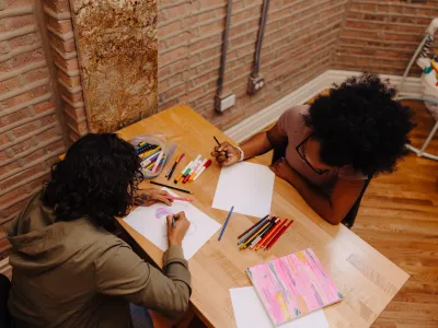 Two residents at Covenant House in Chicago work on art projects together.