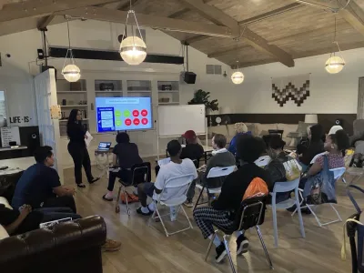 Covenant House California employee walking residents through an educational support slide show and presentation.