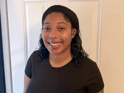 Jahan, a resident of Covenant House New Orleans, stands proudly as she completes her GED and plans for a better future for herself and her baby.